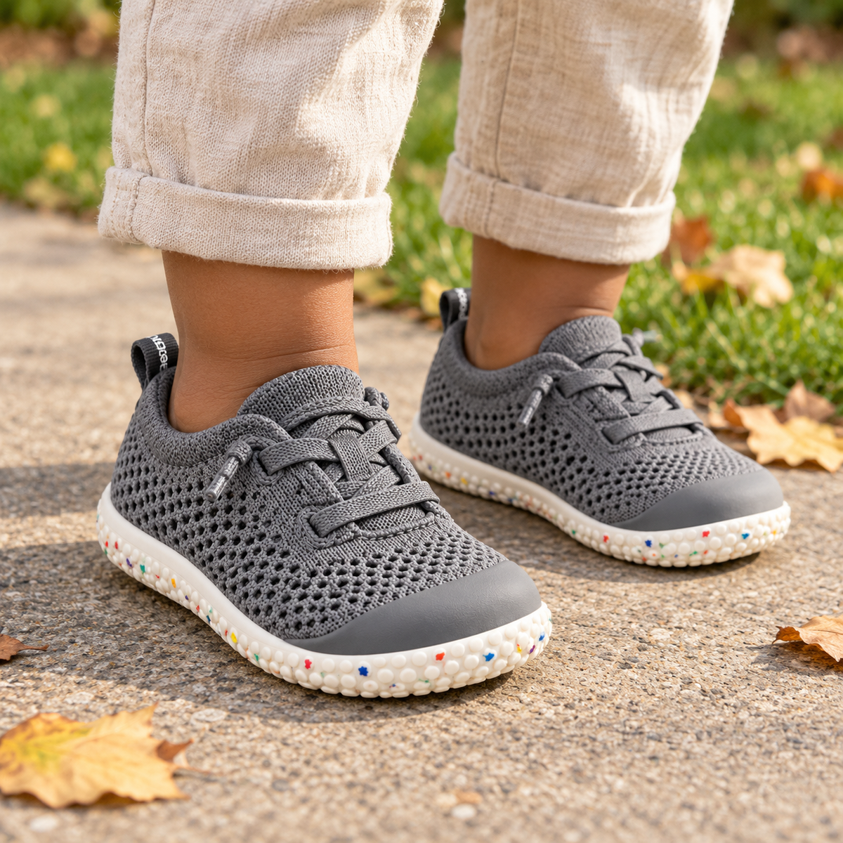 Little feet wearing First Walkers Knit shoes in Grey