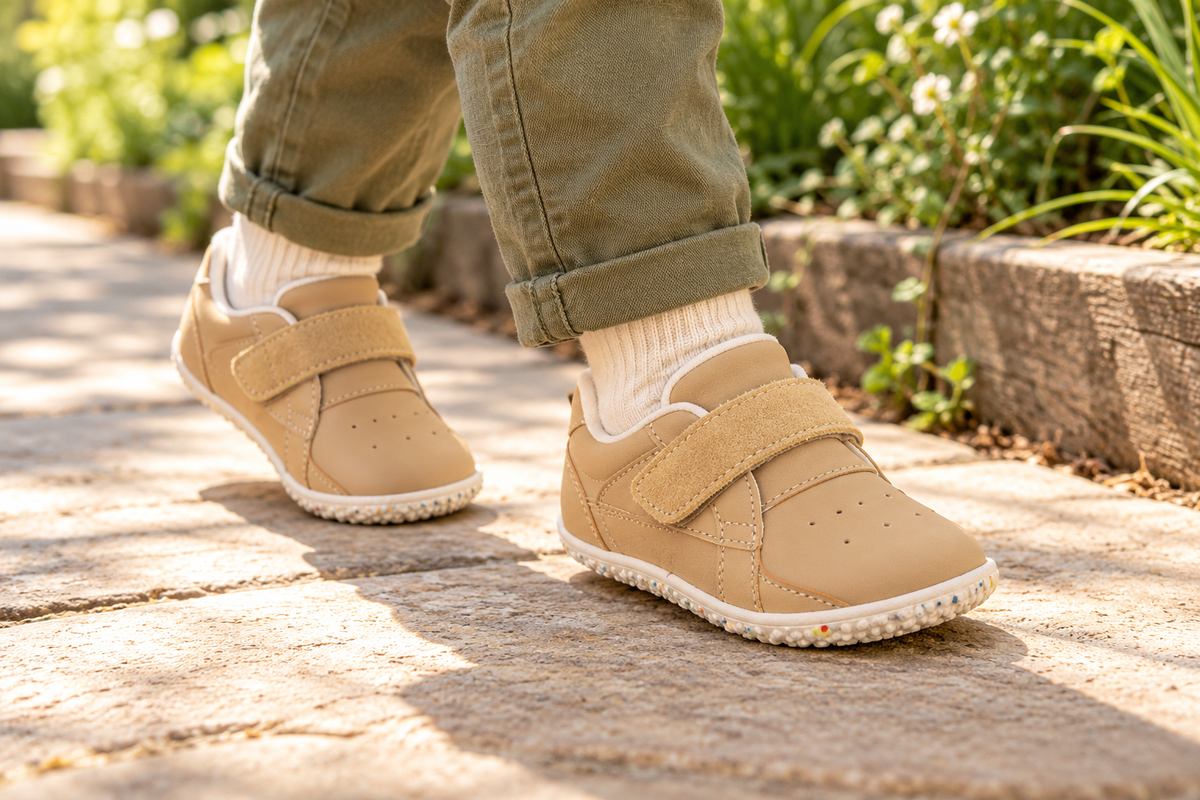 A young child wearing Active Kids — Perforated PU — Brown outdoors