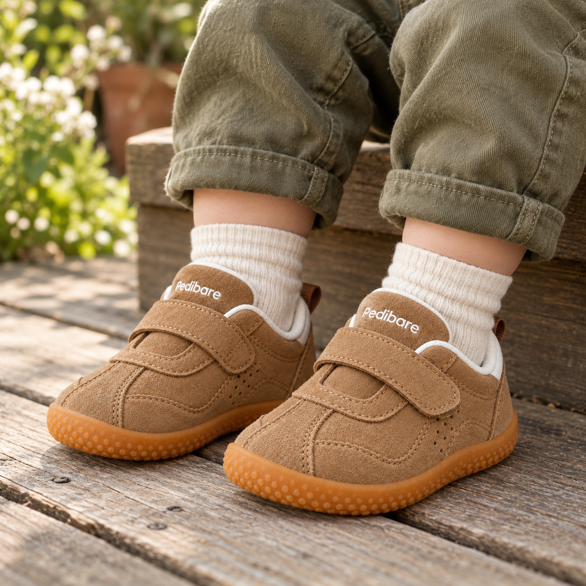 A young child wearing Growing Walkers — Soft PU — Brown outdoors
